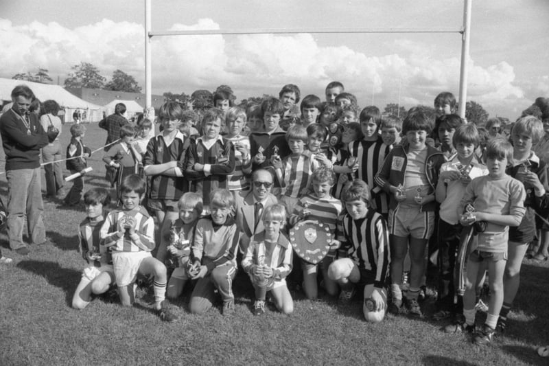 Nobby Stiles presents the Stiles-Kelly Trophy to Tony Reid, captan of Ribbeton Rovers, watched by the finalists and winners of the Under 10s and Under 12s teams who took part in a five-a-side football competition held at Preston Grasshopper's summer spectacular