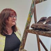 Artist Fiona Hornby examines a pair of 70 year old walking boots at the 'Special Shoes' exhibition currently running  at The Salon in lower St James' Street, Burnley, funded by the Heritage Action Zone (HAZ)