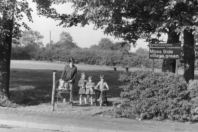 A family enjoying the greenery at Moss Side Village Green in 1975
