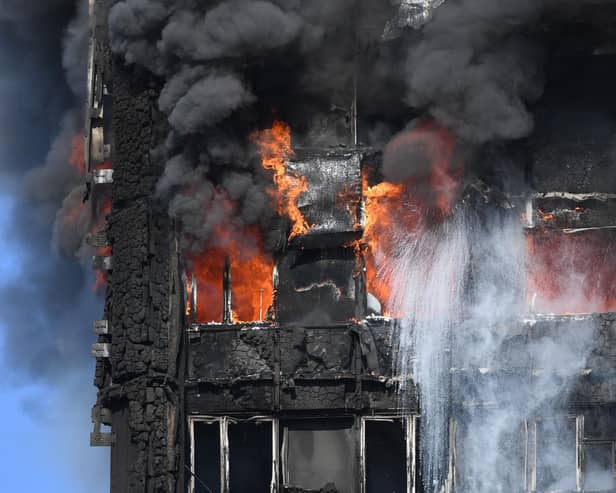 Smoke billows from a fire that has engulfed the 24-storey Grenfell Tower in west London in 2017.