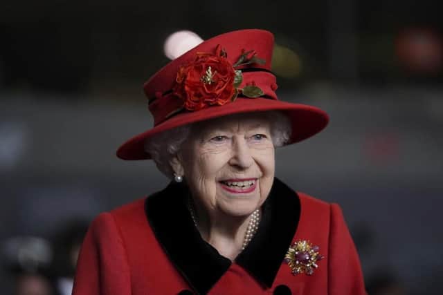 Her Majesty the Queen resplendent in the red of Lancashire.