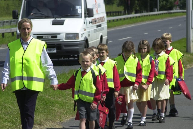 Howick CE Primary School secretary, Pippa Sladen, with pupils from class 2 at the school in Howick, near Preston, practice for the their walking bus - the first in the county. The scheme is aimed at slashing rush-hour traffic outside the school and improving the health and wellbeing of the children 