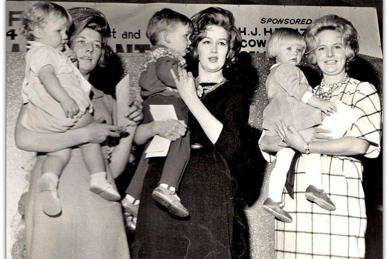The Vin Sumner Collection - The Top Rank Ballroom, Preston, 1960's - 1970's 
Mrs C.V. Broadbent of Warrington (centre) and her baby, winners of the Mother and Baby contest 1964. Sponsored by Cow & Gate Baby Foods.