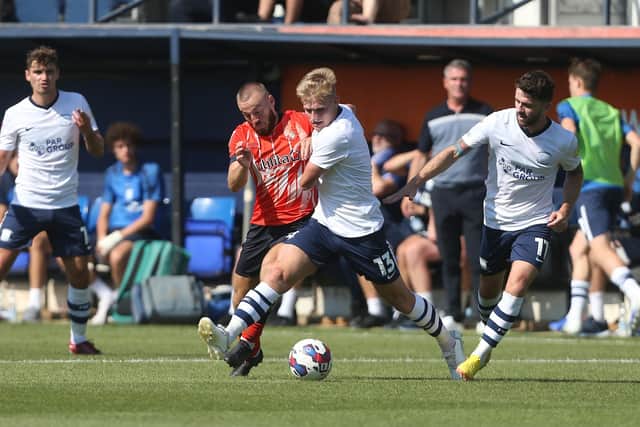 Ali McCann battles for the ball at Kenilworth Road.