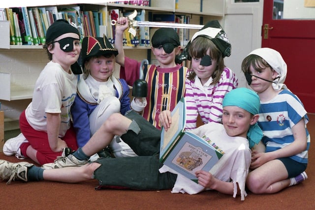 Pirate Chris Weyer reads a book in the new library, surrounded by fellow treasure hunters (from left) Jennifer Carr, Louise Moran, Rachel Roberts, Lisa Gorton and Zoe Dewsbury. The youngsters from Preston's Brockholes Wood County Primary School were celebrating the opening of their library with a special book week.