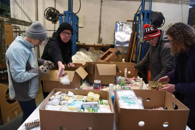 Aid workers sort through donations for Ukraine at an International Aid Trust depot in Lostock Hall.