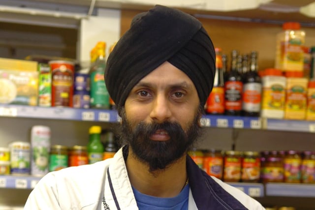 Gary Singh of Singh and Sons, manning the till on his stall on Preston market