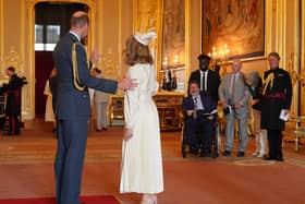 Kate Garraway is watched by her husband Derek Draper, from Chorley, as she is made a Member of the Order of the British Empire by the Prince of Wales at Windsor Castle. The honour recognises services to broadcasting, to journalism and to charity. Picture by Jonathan Brady/PA Wire
