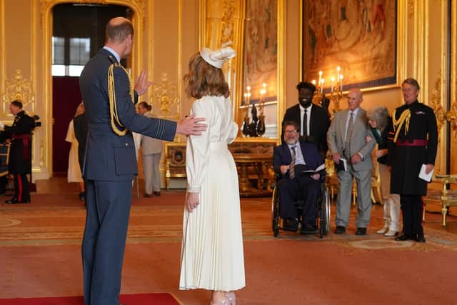 Kate Garraway is watched by her husband Derek Draper, from Chorley, as she is made a Member of the Order of the British Empire by the Prince of Wales at Windsor Castle. The honour recognises services to broadcasting, to journalism and to charity. Picture by Jonathan Brady/PA Wire