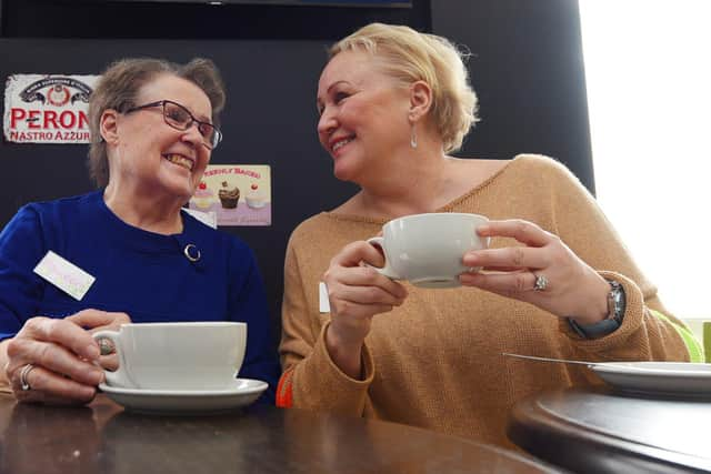 Volunteers Maureen Liptrot and Deana Crawford waiting for the first visitors to arrive at the launch of Buckshaw Village's Talking Tables at the Cappuccino Cafe