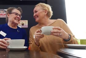Volunteers Maureen Liptrot and Deana Crawford waiting for the first visitors to arrive at the launch of Buckshaw Village's Talking Tables at the Cappuccino Cafe