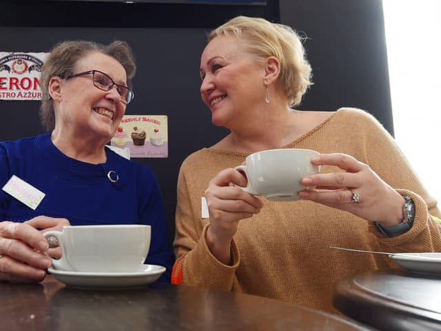 Volunteers Maureen Liptrot and Deana Crawford waiting for the first visitors to arrive at the launch of Buckshaw Village's Talking Tables at the Cappuccino Cafe