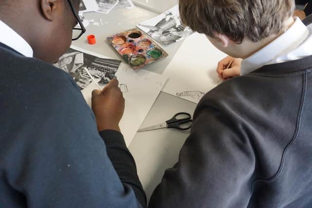 Two students from Preston creating a collage in the planning stages of “The links in the chain are of equal strength”