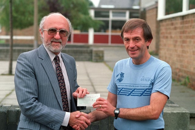 Tulketh High School teacher Terry Dickenson receives a cheque for £800
