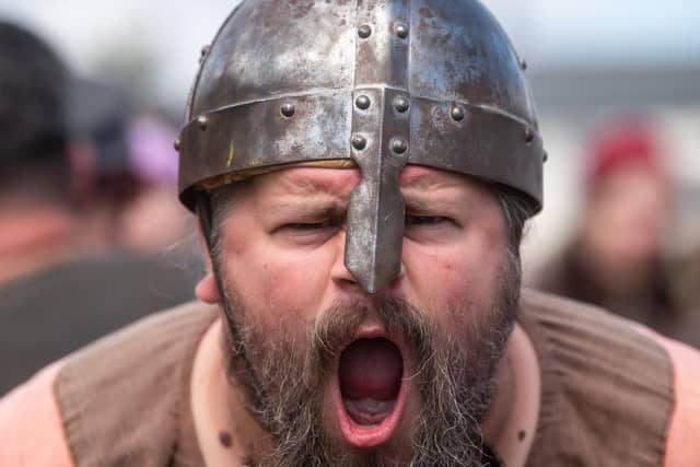 Heysham Viking Festival 2026 - a Viking with a helmet issues a war cry.