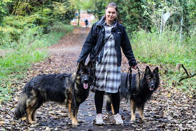 Kamila Dobosz with her German Shepherds which she is now afraid to let off the lead at Lancaster canal in Preston in case they ingest the polluted canal water