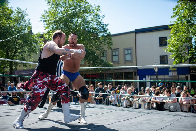 Wrestlers entertaining the crowds in the match outside the Harris on Preston's flag market