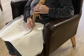 Francis Campbell, 77, meets a lizard from Home Safari at Aaron Crest Care Home