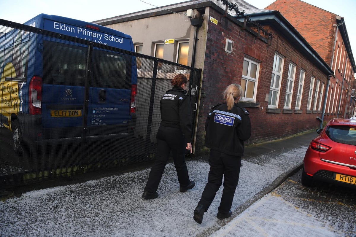 Police pictured patrolling Eldon Primary School in Preston after staff reported receiving threatening messages