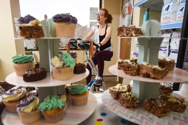 Staff at the Veterinary Health Centre are raising money for Oliver, 16, by riding a bike and selling cakes. Sarah Peak on the bike.