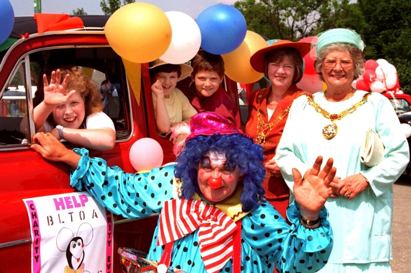 Claie Harper, Danielle Greiffiths and Keith Dawson wave from their taxi as they arrive in Morecambe with their cab driver Neil Cochrane, to a welcome by the Mayor of Lancaster Councillor Janet Horner and Mayoress Kathleen Strong, when 50 taxis ferried 150 children for a day at Frontierland on the Blackpool Licenced Taxi Operators Association, charity run.