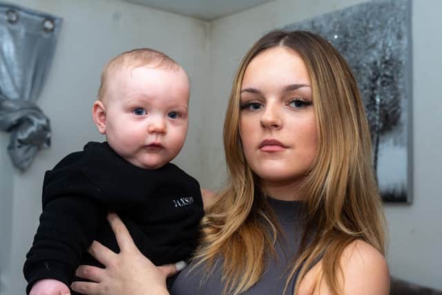 Shanice Innes with seven month old Jaxson Barton inside her bedroom which has developed mould