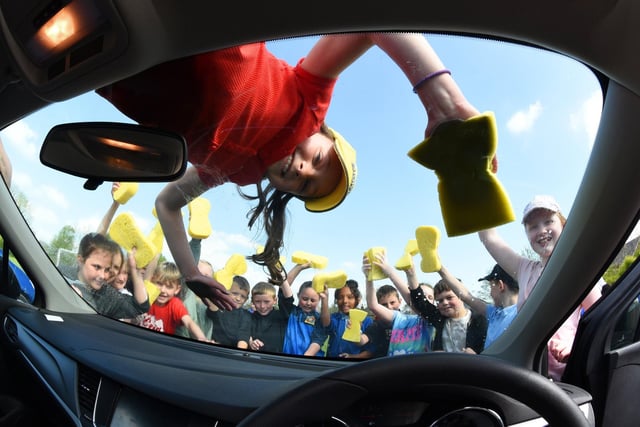 Year 4 pupils washing cars.