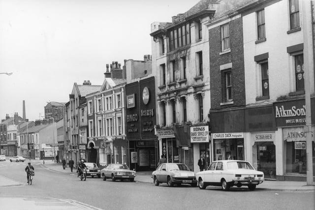 The small building in the centre of this image from 1980 was home to a venue many will be familiar with - Scamps nightclub. Next door is a bingo hall, sitting alongside The Old Dog Inn on Church Street, Preston