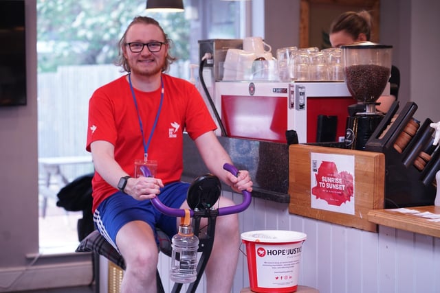 Ben Clarke, supervisor of Valley Coffee in Bamber Bridge, completing the 21-mile cycling challenge on an exercise bike at work.