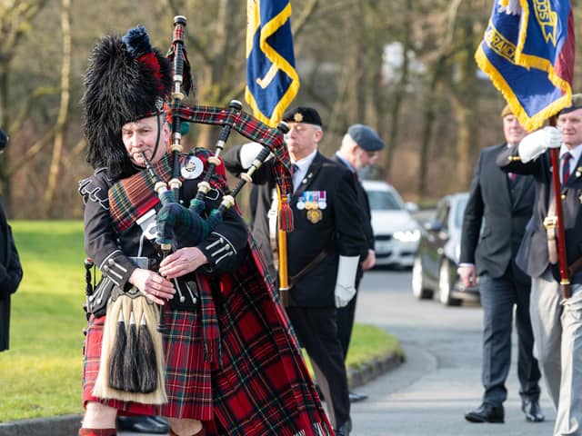 A Scots Guards bagpiper plays as the hearse arrives at Burnley Crematorium for the funeral of veteran Ted Davidson. Photo: Kelvin Lister-Stuttard