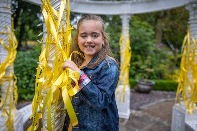 Juliette Hook pictured with some of the yellow ribbons which carry the names of much loved and remembered people and pets.