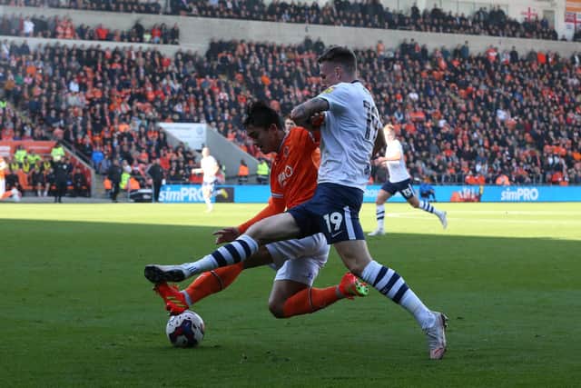 Preston North End's Emil Riis is tackled by Blackpool's Kenny Dougall