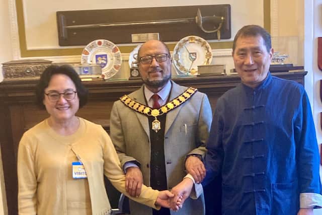 Tina Yuen and Raymond Chung, recently reunited in Preston, met up with city mayor Yakub Patel (centre)