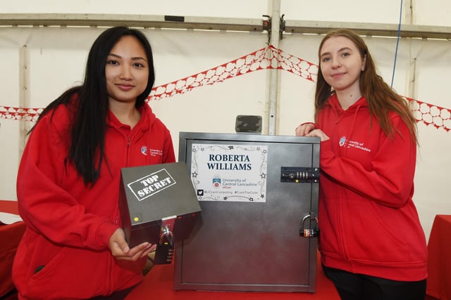 UCLan students Kristy Montalbo and Cristina Florea get members of the public to break the code in their game stall