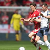 Preston North End skipper Alan Browne battles with his Middlesbrough counterpart Johnny Howson at Deepdale