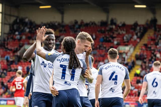 Daniel Johnson celebrates scoring his side's second goal with team-mates Bambo Diaby (left) and Emil Riis Jakobsen (right)