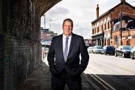 Carl Chinn underneath the railway arches in Adderley Street where the first Peaky Blinders assaulted an innocent man because he had been drinking a ginger beer in the Rainbow pub (seen in the background on the right).