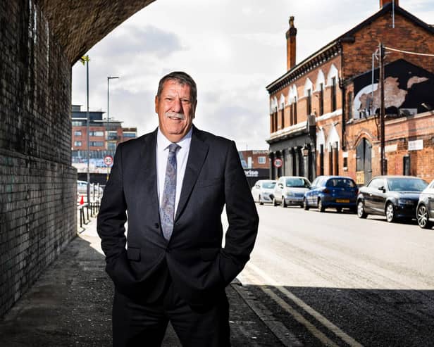 Carl Chinn underneath the railway arches in Adderley Street where the first Peaky Blinders assaulted an innocent man because he had been drinking a ginger beer in the Rainbow pub (seen in the background on the right).