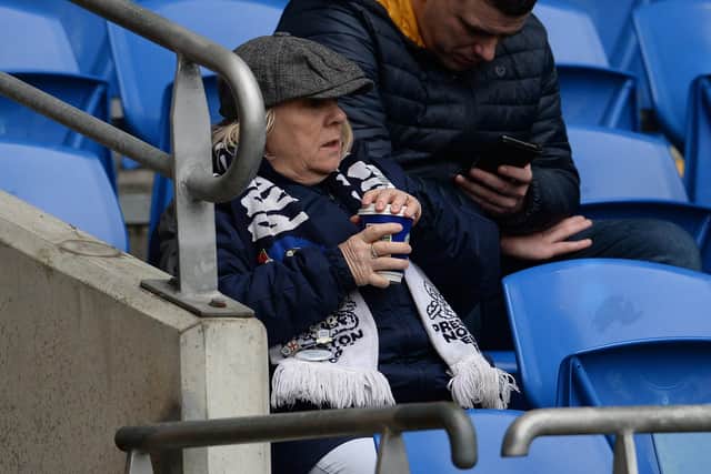 A North End fan enjoys the pre-match atmosphere