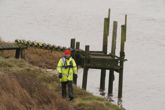 A member of the police Search and Rescue team walks along the river bank near to Shard Bridge on the River Wyre in Lancashire, as police continue their search for missing woman Nicola Bulley, 45, who was last seen two weeks ago on the morning of Friday January 27, when she was spotted walking her dog on a footpath by the nearby River Wyre. Picture date: Friday February 10, 2023.