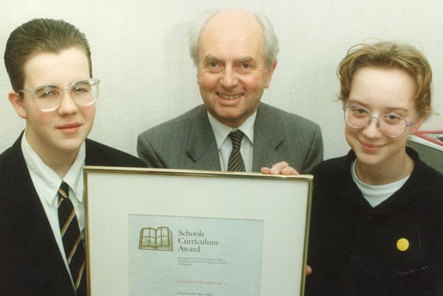 Pictured are Mark Anderton, Mr Harry Eccles, and Laura Nicholson - showing off Ashton's High School's curriculum award, as the school were presented with the national commendation in recognition of top quality education and community links for the second time back in 1992