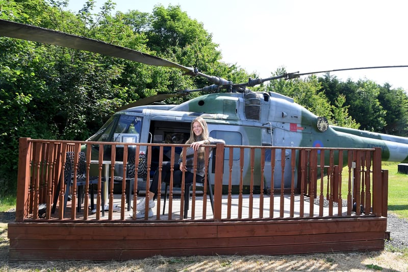 Katie relaxes on the decking outside the Lynx helicopter
