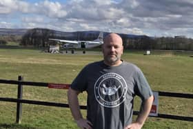 Richard at the airfield across from the plane that took him to 15,000ft for his skydive
