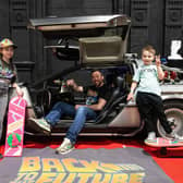 Francesca, Gavin and Edward Conner with a Delorean at the Future Fanfest at the Winter Gardens
