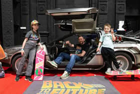 Francesca, Gavin and Edward Conner with a Delorean at the Future Fanfest at the Winter Gardens
