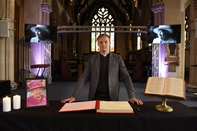 The Vicar of Preston Rev Sam Haigh with the Minster's book of condolence.