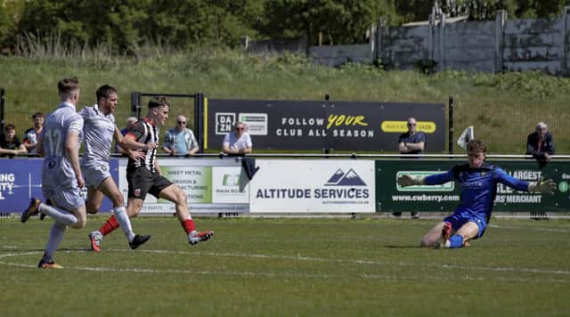 Max Wilson slots home on Chorley’s grass pitch against Worksop Town in the final game of last season