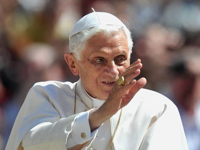 Pope Benedict XVI waves to crowds in 2012