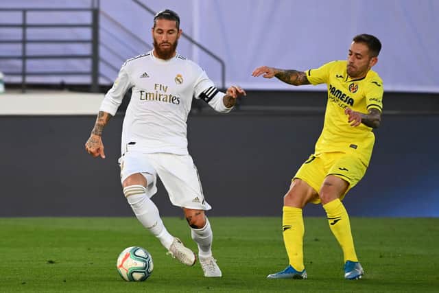 Villarreal's Spanish defender Xavi Quintilla (R) challenges Real Madrid's Spanish defender Sergio Ramos during the Spanish League football match between Real Madrid CF and Villarreal CF at the Alfredo di Stefano stadium in Valdebebas, on the outskirts of Madrid, on July 16, 2020. (Photo by GABRIEL BOUYS / AFP) (Photo by GABRIEL BOUYS/AFP via Getty Images)