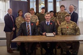 Gary Oakford from the Ministry of Defence hands Stonyhurst a bronze award for its commitment to the Armed Forces Covenant (AFC).